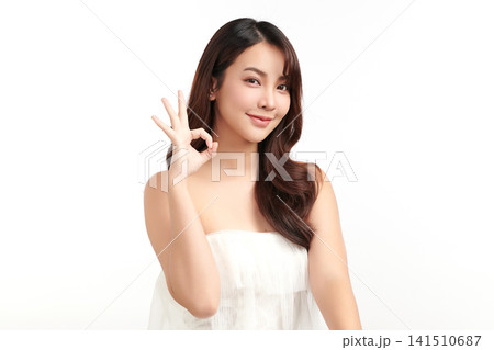 A beautiful young Asian woman with clean, fresh skin against a white background. Skincare, facial treatment, cosmetology, beauty, and spa. An elegant portrait of an Asian woman. A beautiful young Asian woman with clean, fresh skin against a white background. Skincare, facial treatment, cosmetology, beauty, and spa. An elegant portrait of an Asian woman. 141510687