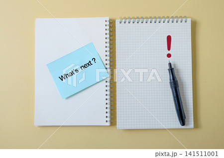 Text What's next on notepad paper on color background. Text What's next on notepad paper on color background. 141511001