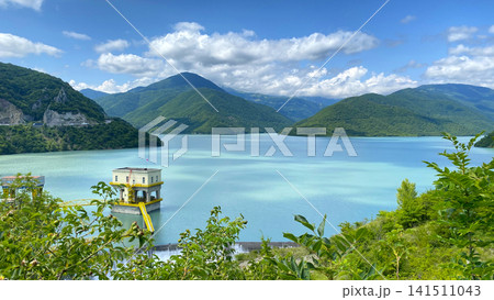 Zhinvali Reservoir stores mountain water beside a dam intake tower in Georgia, shown from an elevated viewpoint Zhinvali Reservoir stores mountain water beside a dam intake tower in Georgia, shown from an elevated viewpoint 141511043