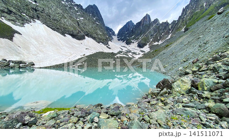 White Abudelauri Lake reflects snowbound Chaukhi peaks in Georgia, combining turquoise water and rocky shores for regional tourism promotion White Abudelauri Lake reflects snowbound Chaukhi peaks in Georgia, combining turquoise water and rocky shores for regional tourism promotion 141511071