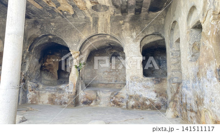 Ancient rock-cut hall inside Uplistsikhe features carved arches, columns, niches, and weathered stone surfaces in Georgia Ancient rock-cut hall inside Uplistsikhe features carved arches, columns, niches, and weathered stone surfaces in Georgia 141511117