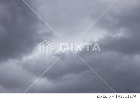 Soft Gray Storm Clouds with a Pale Opening in a Full Frame Overcast Sky Soft Gray Storm Clouds with a Pale Opening in a Full Frame Overcast Sky 141511274