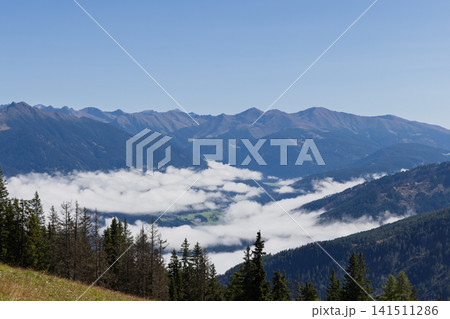 Fog-Filled Alpine Valley and Distant Ridges Seen from Kronplatz, Italy Fog-Filled Alpine Valley and Distant Ridges Seen from Kronplatz, Italy 141511286