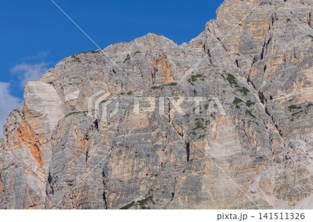 Fractured limestone and orange rock details across the Col Bechei mountain face Fractured limestone and orange rock details across the Col Bechei mountain face 141511326