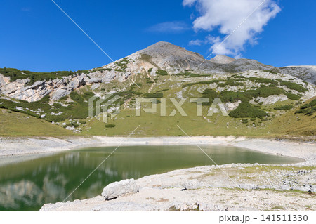 On the Fanes plateau, green Lago di Limo lies below the grassy flank of Col Bechei 141511330