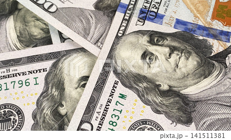 Close-up portrait of Benjamin Franklin. Cash banknotes. One hundred US dollars. The American national currency. $100 bills. Background of cash dollar bills. Close-up portrait of Benjamin Franklin. Cash banknotes. One hundred US dollars. The American national currency. $100 bills. Background of cash dollar bills. 141511381