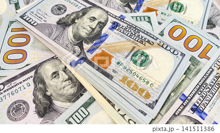 Background of cash dollar bills. One hundred US dollars. Background of money. Cash banknotes. $100 bills. The American national currency. Background of cash dollar bills. One hundred US dollars. Background of money. Cash banknotes. $100 bills. The American national currency. 141511386