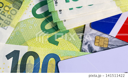 Credit cards and 100 euro bills. The single currency of the European Union. Close-up. Cash banknotes of one hundred euros. Credit cards and 100 euro bills. The single currency of the European Union. 141511422