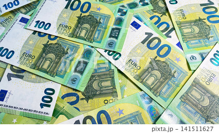 View of the scattered 100 euro bills. Cash banknotes. One hundred euros. Economics and finance. European currency. Background of cash Euro notes. View of the scattered 100 euro bills. Cash banknotes. One hundred euros. Economics and finance. European currency. Background of cash Euro notes. 141511627