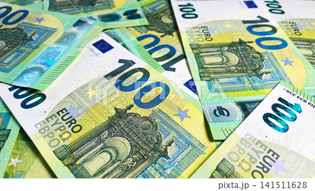 Background of cash Euro notes. One hundred euros. Economics and finance. View of the scattered 100 euro bills. Cash banknotes. European currency. Background of cash Euro notes. One hundred euros. Economics and finance. View of the scattered 100 euro bills. Cash banknotes. European currency. 141511628