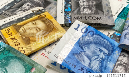 Cash banknotes of Kyrgyzstan. Business and finance. Folded in half bills in 5000, 1000 and 200 som, the current money of Kyrgyzstan. Cash banknotes of Kyrgyzstan. Business and finance. Folded in half bills in 5000, 1000 and 200 som, the current money of Kyrgyzstan. 141511715