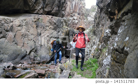 Two siblings are walking in the mountains. Two men went on a trip around the world. Travel, tourism, and trekking. Freedom Two siblings are walking in the mountains. Two men went on a trip around the world. Travel, tourism, and trekking. Freedom 141511783