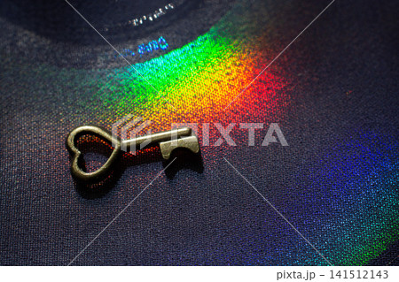 Vintage key. .Antique key. Retro key with a heart shape on on colorful fabric Vintage key. .Antique key. Retro key with a heart shape on on colorful fabric 141512143