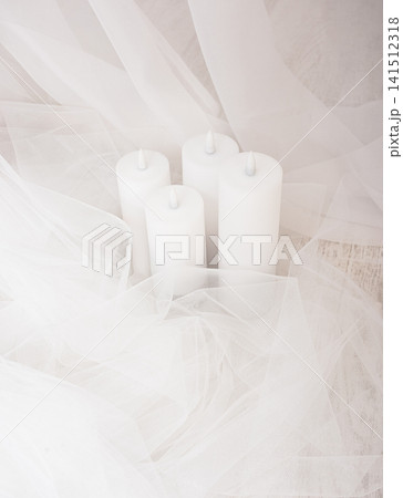 Top view of group of white candles among airy fabric Top view of group of white candles among airy fabric 141512318