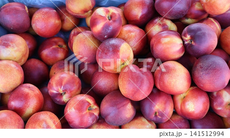 View of a large pile of fresh ripe nectarines 141512994