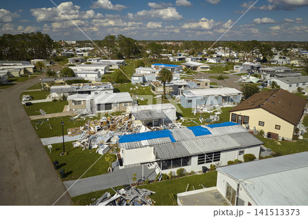 Severely damaged by hurricane Ian houses in Florida mobile home residential area. Consequences of natural disaster Severely damaged by hurricane Ian houses in Florida mobile home residential area. Consequences of natural disaster 141513373