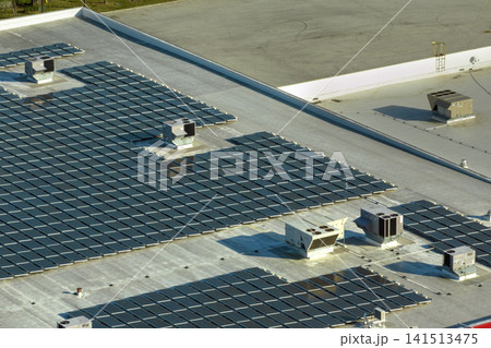 Photovoltaic solar panels mounted on industrial building roof for producing green ecological electricity. Production of sustainable energy concept 141513475
