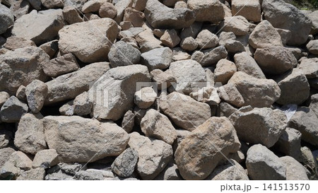 Close-up photograph of a pile of large gray and beige rocks with rough, weathered texture, stones concept. Close-up photograph of a pile of large gray and beige rocks with rough, weathered texture, stones concept. 141513570