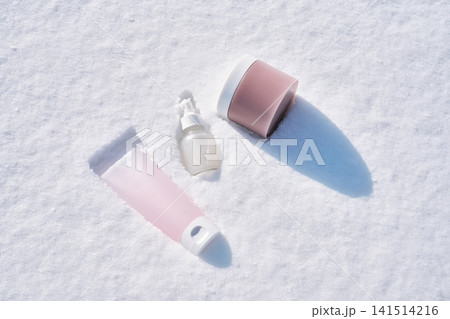 Skincare products set on white winter snow Skincare products set on white winter snow 141514216
