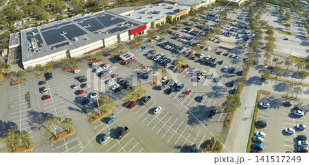 Top view of many cars parked on a parking lot in front of a shopping mall in Florida. Concept of urban transportation Top view of many cars parked on a parking lot in front of a shopping mall in Florida. Concept of urban transportation 141517249