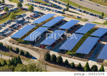 Sustainable power production integrated in urban infrastructure. Photovoltaic solar panels over car parking place for generation of renewable energy. Sustainable power production integrated in urban infrastructure. Photovoltaic solar panels over car parking place for generation of renewable energy. 141517279