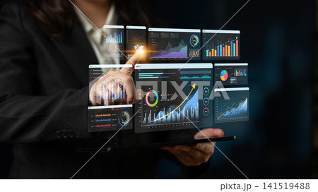 Business Professional Interacting with Futuristic Data Visualization Interface on Tablet Screen in Modern Office Setting. Bitwise Business Professional Interacting with Futuristic Data Visualization Interface on Tablet Screen in Modern Office Setting. Bitwise 141519488