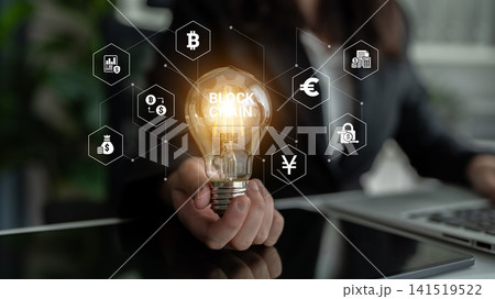 Light Bulb Symbolizing Blockchain Technology with Icons of Currency and Security in Modern Office Setting. Glyphic Light Bulb Symbolizing Blockchain Technology with Icons of Currency and Security in Modern Office Setting. Glyphic 141519522