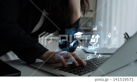 Woman Working on Laptop with Virtual Skill Icons and Educational Graphics Representing Online Learning and Professional Development Quark 141519571