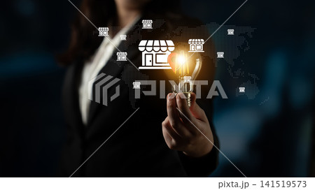 Businesswoman Holding Light Bulb with Store Icons in a World Map Background for Concept of Innovation and Global Commerce Opportunities Gantry Businesswoman Holding Light Bulb with Store Icons in a World Map Background for Concept of Innovation and Global Commerce Opportunities Gantry 141519573
