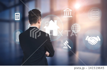 Professional Man in Suit Contemplating Real Estate Decisions with Digital Icons Representing Finance, Law, and Global Connectivity in Modern Office Environment Haptic 141519645