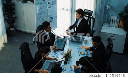 Top view of female leader looking financial statistic at meeting. Directorate. Top view of female leader looking financial statistic at meeting. Directorate. 141519646