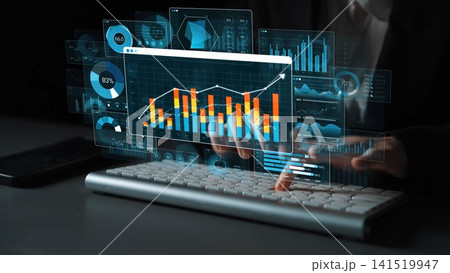 Dynamic digital interface displaying data visualization, charts, and graphs while a user interacts with a keyboard in a modern workspace, symbolizing business analysis and technology trends. Sigmoid 141519947