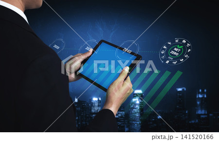 Business professional using tablet to analyze data trends in digital graph with net zero target concept against urban skyline in blue tone Gantry Business professional using tablet to analyze data trends in digital graph with net zero target concept against urban skyline in blue tone Gantry 141520166
