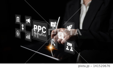 Professional Hands Using Tablet for Digital Marketing with Pay Per Click Strategy and Icons for Advertising Campaigns in a Dark Environment Ledger 141520676
