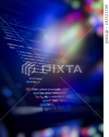 Vertical abstract technology background. Colorful glowing bokeh flares over computer screen displaying programming code. Vertical abstract technology background. Colorful glowing bokeh flares over computer screen displaying programming code. 141521799