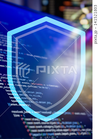 Cyber Security Shield Concept: Glowing Blue Futuristic Protection Icon Over Blurred Programming Code Background Cyber Security Shield Concept: Glowing Blue Futuristic Protection Icon Over Blurred Programming Code Background 141521803