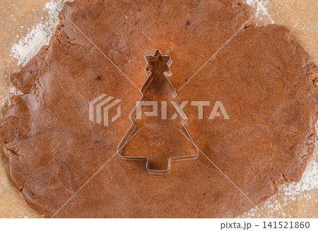 Christmas Tree Cookie Cutter on Gingerbread Dough for Holiday Baking Christmas Tree Cookie Cutter on Gingerbread Dough for Holiday Baking 141521860
