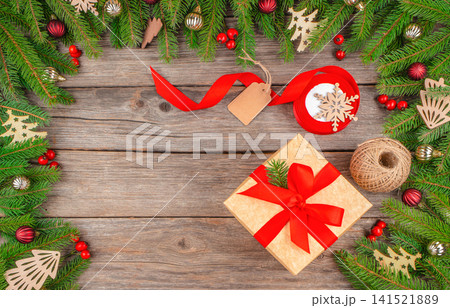Christmas Gift with Festive Decoration on Rustic Wooden Background Christmas Gift with Festive Decoration on Rustic Wooden Background 141521889