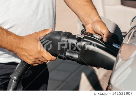 Electric Vehicle Charging Using Adapter at EV Charging Station Electric Vehicle Charging Using Adapter at EV Charging Station 141521907
