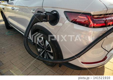 Electric Vehicle Charging with Adapter Connected to EV Battery Electric Vehicle Charging with Adapter Connected to EV Battery 141521910