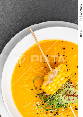 Creamy Corn Soup with Grilled Corn Garnish Closeup 141522083