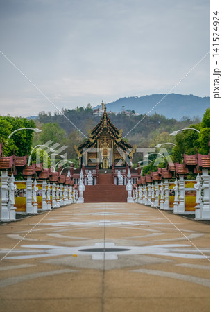 Traditional Thai temple in Rajapruek park with symmetrical pathway and statues in Chiang Mai, Ornate Asian shrine architecture with stairs and cultural landmark in Thailand Traditional Thai temple in Rajapruek park with symmetrical pathway and statues in Chiang Mai, Ornate Asian shrine architecture with stairs and cultural landmark in Thailand 141524924