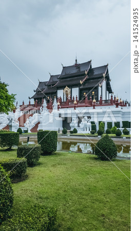 Traditional Thai temple pavilion with garden and pond at Royal Park Rajapruek, Ornate palace architecture with symmetrical landscape and greenery in Chiang Mai Traditional Thai temple pavilion with garden and pond at Royal Park Rajapruek, Ornate palace architecture with symmetrical landscape and greenery in Chiang Mai 141524935