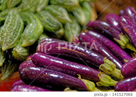 Fresh Long Purple Eggplants and Bitter Melons at Market 141527068