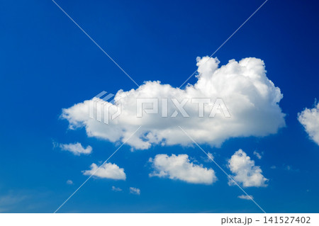 elongated white cloud of interesting shape in the center of a rich blue sky background elongated white cloud of interesting shape in the center of a rich blue sky background 141527402