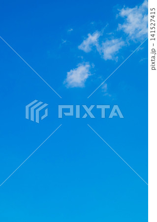a lonely white cloud in a high pure blue sky on a clear sunny day 141527415