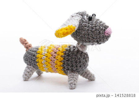 Knitted woolen dog on a white background Knitted woolen dog on a white background 141528818