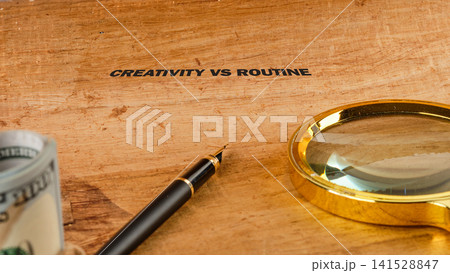 Sunlight hits professional writing tools on a textured timber desk, capturing the balance between artistic expression and daily habit Sunlight hits professional writing tools on a textured timber desk, capturing the balance between artistic expression and daily habit 141528847