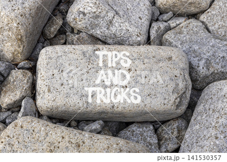 Tips and tricks words symbol. Concept words Tips and tricks on beautiful grey stone. Beautiful grey stones background. Business tips and tricks motivational support concept. Copy space. Tips and tricks words symbol. Concept words Tips and tricks on beautiful grey stone. Beautiful grey stones background. Business tips and tricks motivational support concept. Copy space. 141530357