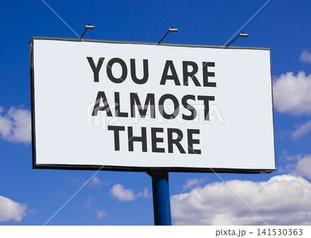 You are almost there symbol. Concept words You are almost there on beautiful big white billboard. Beautiful blue sky background. Business You are almost there motivational support concept. Copy space 141530363